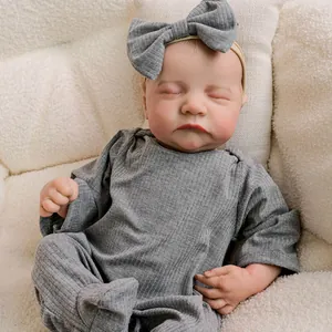 Lifelike 18 inch reborn baby doll Levi sleeping in grey romper and bow headband