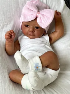 Detail of 18 inch dark skin doll wearing white bodysuit and pink bow striped hat