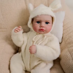 Realistic 19-inch reborn baby doll in fuzzy white bunny jumpsuit on cozy background