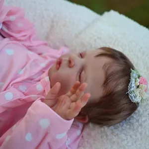 Realistic 19-inch reborn sleeping baby doll Louisa in pink heart pajamas and flower headband