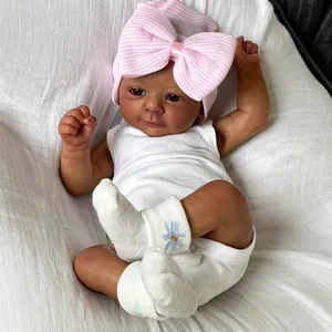 18 inch lifelike African American reborn baby doll in white romper with pink bow hat