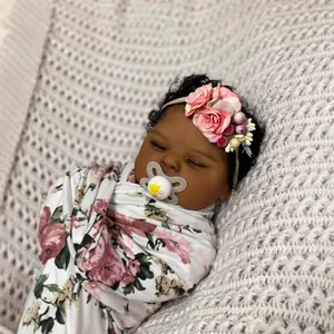 Lifelike 19-inch reborn baby doll sleeping in floral swaddle with flower headband