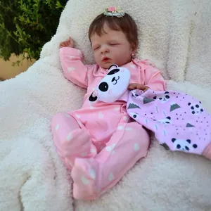 Lifelike 19-inch reborn baby doll Louisa in pink heart onesie sleeping on white fur rug