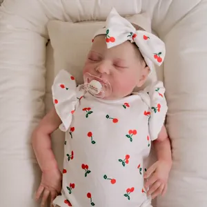 Lifelike 19-inch reborn baby doll sleeping in cherry print romper with pacifier