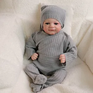 Realistic 18-inch newborn baby doll in grey waffle knit outfit and pointed beanie hat