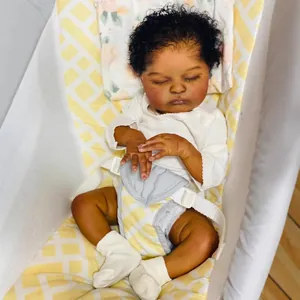 Realistic 19-inch dark-skinned reborn baby doll in white onesie with curly black hair