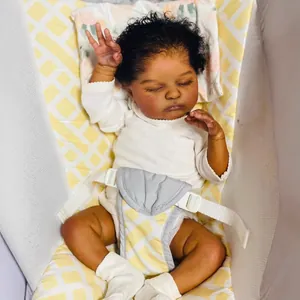 Realistic 19-inch reborn sleeping baby doll with dark skin and white long-sleeve jumpsuit