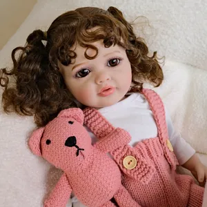 55cm lifelike reborn baby doll Betty with curly hair and pink knit overalls