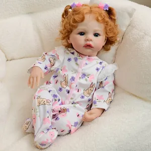Lifelike 19-inch reborn baby doll Meadow with ginger hair and floral bunny romper suit
