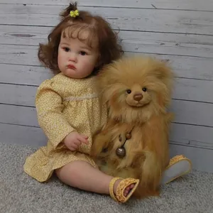 24-inch realistic reborn girl doll in yellow floral dress with a plush teddy bear