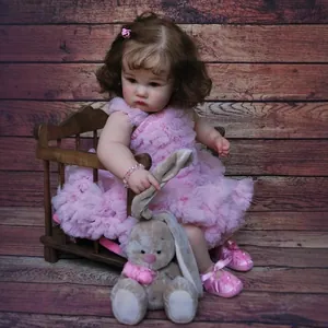 24-inch lifelike reborn toddler doll in pink ruffled dress with brown curly hair
