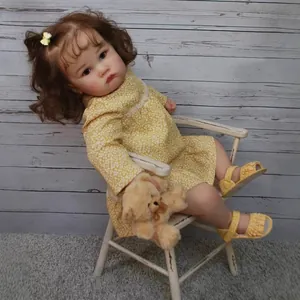 24-inch realistic reborn toddler doll in yellow floral dress with teddy bear accessory