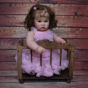 24 inch realistic reborn toddler girl doll with curly hair in a pink tutu dress