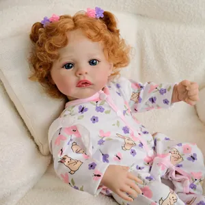 Realistic 19-inch reborn baby doll with curly auburn hair and floral rabbit onesie