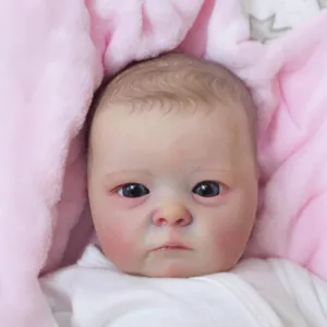 Realistic 16-inch reborn baby doll with white sleeves wrapped in pink plush blanket