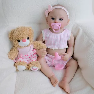 Reborn baby doll Raven in pink plaid outfit with magnetic pacifier and teddy bear