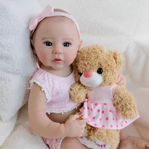 Realistic 49cm Reborn Baby Doll Raven in pink plaid outfit with teddy bear companion