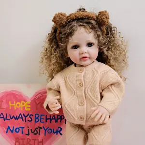 22-inch Betty reborn doll with brown curly hair wearing a beige knit sweater and bear ears