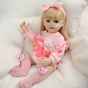 Lifelike 22-inch reborn baby doll in pink floral sweatshirt and adorable cat socks
