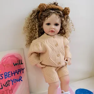 22-inch Betty reborn doll with brown curly hair wearing a beige knit sweater set