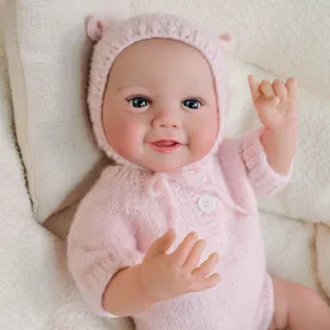 Lifelike 19-inch reborn baby doll in a pink knit romper and hat with blue eyes