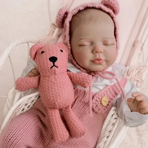 20-inch lifelike reborn baby doll in pink knitted romper sleeping with a crochet bear