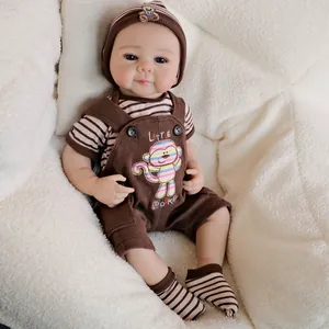 19-inch realistic reborn baby doll Julietta in monkey overall suit on plush background