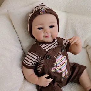 Lifelike 19-inch Reborn baby doll with blue eyes in a brown monkey overalls outfit