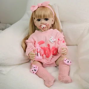 Lifelike 22-inch reborn baby doll with blonde hair, pink outfit, and toy accessories