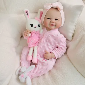 Realistic 19 inch reborn baby doll in pink fleece romper with plush bunny accessory