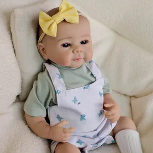 19-inch realistic reborn baby doll Julietta in bird print overalls and yellow headband