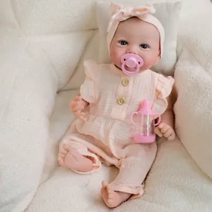 19-inch realistic reborn baby doll Emmy in pink ruffle bodysuit and matching headband
