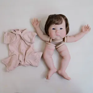 22-inch painted reborn doll kit with blue eyes, brown hair and pink baby bodysuit