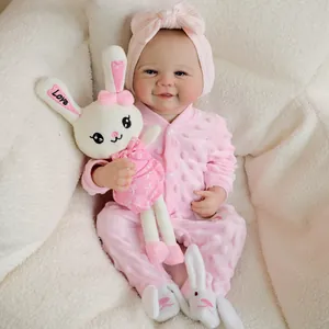 Realistic 19 inch reborn doll in pink polka dot romper with bunny plush and matching shoes