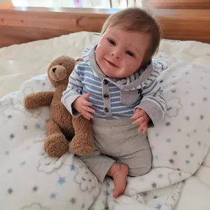 19-inch realistic reborn doll wearing blue striped hoodie and grey pants with teddy bear