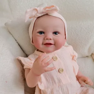 Lifelike 19-inch reborn baby doll in pink sleeveless ruffled romper with matching headband