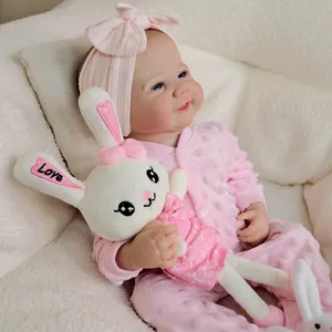 19-inch lifelike reborn baby doll in pink polka dot outfit with plush bunny accessory