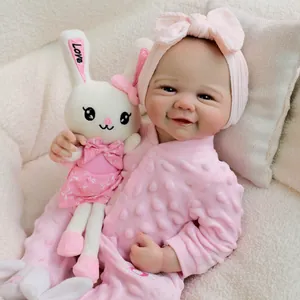 Realistic 19-inch reborn baby doll in pink romper with white plush rabbit toy
