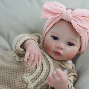 Realistic 18-inch reborn baby doll in brown waffle romper with pink headband