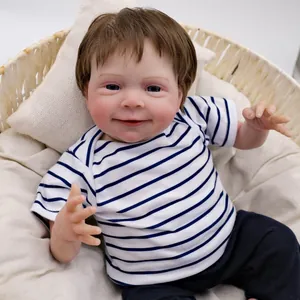19-inch lifelike reborn baby doll in blue striped t-shirt lying in a wicker basket