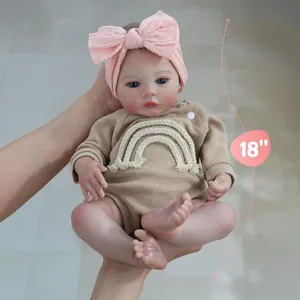Realistic 18-inch reborn baby doll in khaki knit romper and pink bow headband