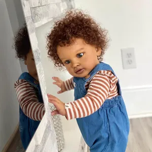 26-inch deep skin Pippa reborn doll wearing denim overalls and striped long sleeve