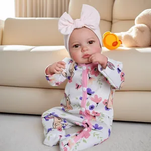 Lifelike 19 inch Loulou reborn baby doll in bunny jumpsuit on beige sofa