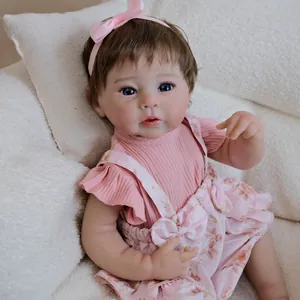 Realistic 19-inch Raven reborn baby doll in pink floral overall dress and headband