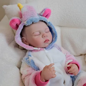 Lifelike Reborn Baby Doll Charlotte in pink unicorn onesie on soft white fleece