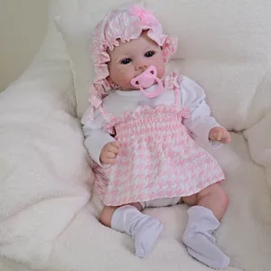 19-inch lifelike reborn baby doll Julietta in pink houndstooth dress and sun hat