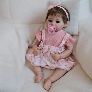 Realistic 19 inch reborn baby doll Raven in pink floral outfit with pacifier