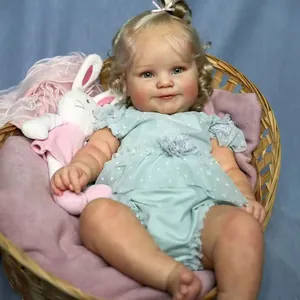 Lifelike 50cm reborn Maddie doll with golden hair and green dress in a woven basket