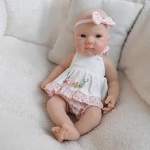 Realistic 8-inch silicone baby doll with blue eyes in pink floral dress and headband