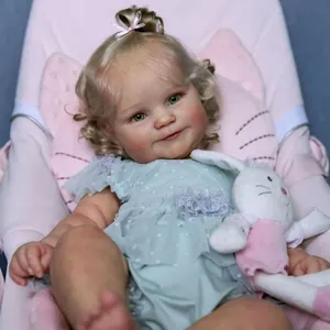 Detailed 50cm Maddie reborn doll with blonde hair and bunny plush in a pink seat